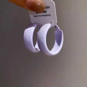 Close-up showing the smooth lavender purple spray-painted finish of round hoop earrings