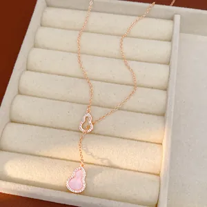 Detail view of pink gourd pendant necklace with sparkling zircons in a jewelry box