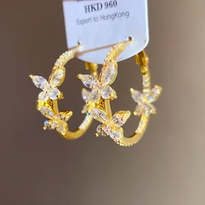 Detailed view of elegant gold-plated butterfly hoop earrings with sparkling zircon stones