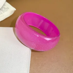 Stylish chunky pink glitter resin bangle with an irregular geometric dome design