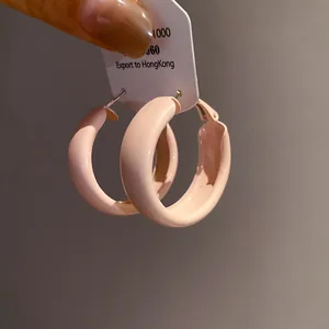 Chunky light pink spray-painted hoop earrings for a minimalist look