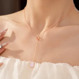 Detail shot of a rose gold calabash necklace with pink inlay and zircon accents