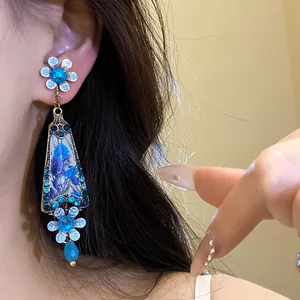 Close-up detail of a vintage palace style resin flower dangle earring worn on ear