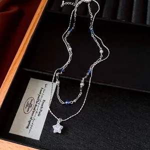 Double-layered silver necklace with blue beads, pearls and a CZ star pendant in box