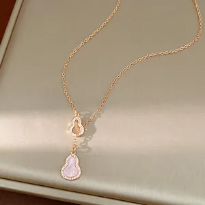 Close-up of rose gold necklace featuring pink hulu pendant with pavé zircon detail