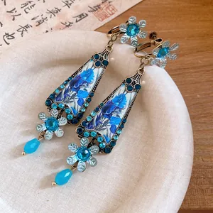 Close-up of vintage blue floral drop earrings with rhinestones and palace style