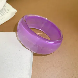 Detailed view of a purple translucent resin chunky bangle with a sparkling glitter finish