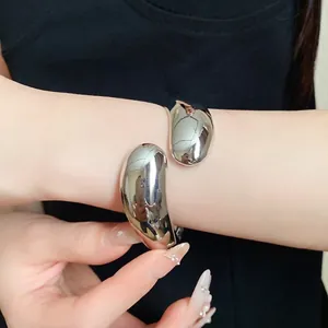 Minimalist silver teardrop cuff bracelet with high-polish mirror finish design