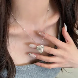 Detailed macro view of an elegant silver beaded heart pendant necklace for women