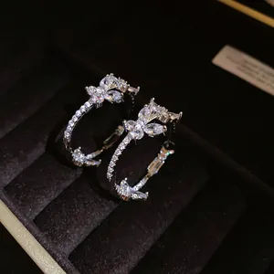 Detailed close-up of 18k gold plated butterfly hoop earrings with cubic zirconia