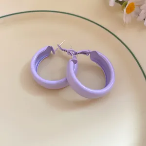 Detailed view of lavender spray-painted round hoop earrings with elegant silver needles finish
