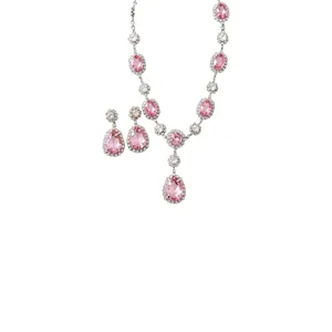 Elegant pink teardrop crystal jewelry set including necklace and halo stud earrings.