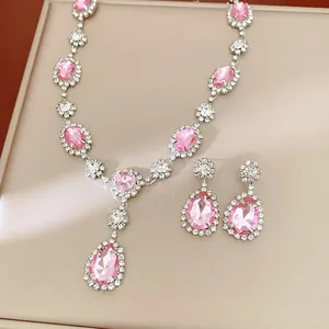 Exquisite close-up of pink teardrop and oval rhinestone necklace with matching earrings