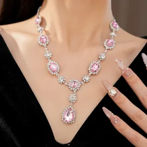Close-up detail of a elegant pink rhinestone necklace with oval and teardrop crystals.