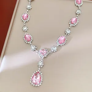 Close-up detail of pink oval and teardrop rhinestone necklace with silver setting