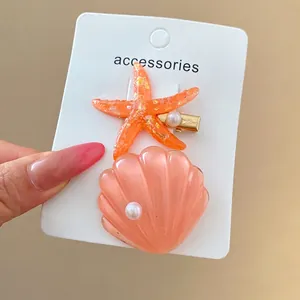 Sweet shell and starfish hair clips set with elegant pearl details for beach vacation style