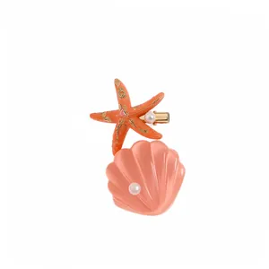 Sweet ocean style hair clip with pink shell, orange starfish and pearls on white background