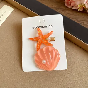 Sweet starfish and peach seashell hair clip with pearls for beach vacation hairstyles