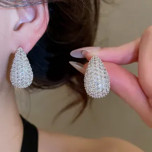 Detailed close-up of teardrop stud earrings with pave-set sparkling cubic zirconia