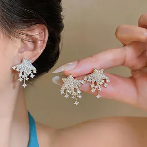 Close-up detail of elegant star-shaped stud earrings featuring shimmering rhinestones