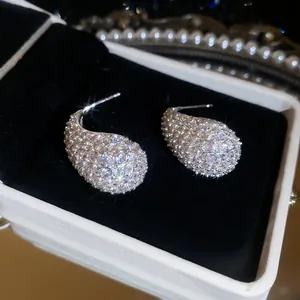 Detailed macro shot of shimmering waterdrop earrings with micro-pave cubic zirconia.