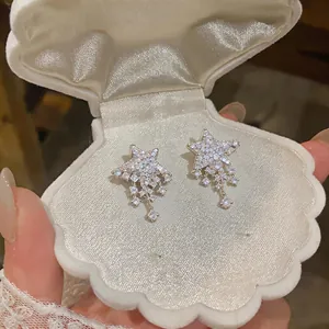 Sparkling full-diamond star drop earrings with cubic zirconia in a white shell jewelry box