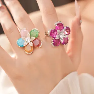Exquisite 18k gold plated open rings featuring vibrant zircon flower designs on model