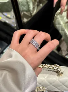 Detailed view of an elegant silver lace open ring with shimmering zircons on index finger