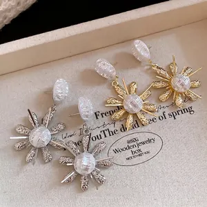 Elegant French vintage flower drop earrings with textured pearls in gold and silver.