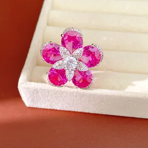 Detailed view of an elegant flower ring featuring vibrant pink zircons in a jewelry box