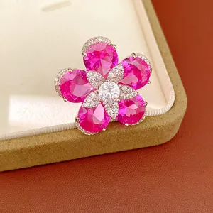 Detail of an 18k gold plated flower ring featuring vibrant pink zircon petals