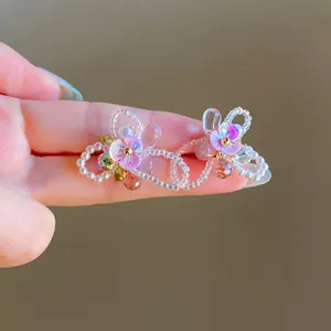Macro detail of Y2K style colorful beaded earrings with iridescent flower charms