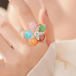 Macro detail of 18k gold plated flower ring featuring colorful stones and zircons