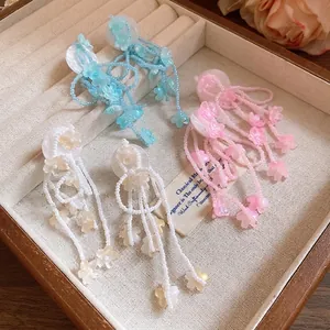 Elegant handmade resin flower tassel earrings set in blue, pink, and white floral designs.