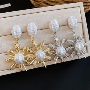 Detailed macro view of French vintage earrings with pleated pearls and flower design