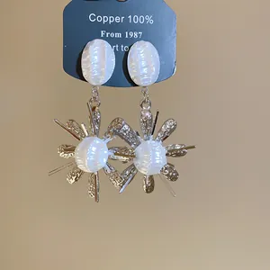 Exquisite detail of French vintage pleated pearl flower earrings with gold metallic finish