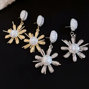 Exquisite detail of French vintage gold and silver flower earrings with wrinkled pearls
