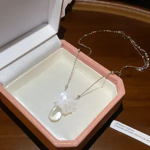 Detail of French style floral resin necklace with a teardrop pendant in a gift box.
