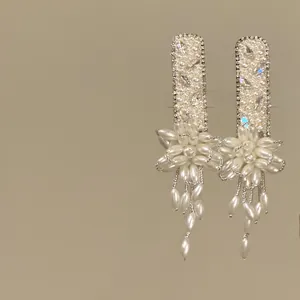 Elegant French style pearl flower tassel hair clips featuring shimmering rhinestone details