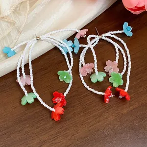 Detailed view of colorful resin flower beaded tassel earrings with silver needles.