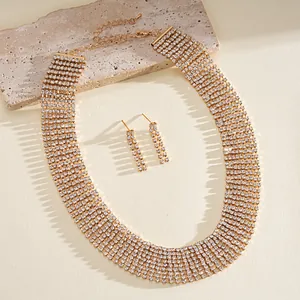 Detailed shot of gold-tone multi-row rhinestone tassel necklace and earrings set