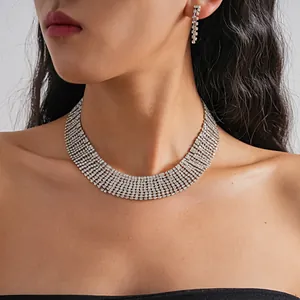 Elegant heavy-duty multi-row rhinestone choker and matching tassel earring set on model