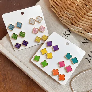 Detail of colorful camellia and clover stud earring sets in various dopamine colors.