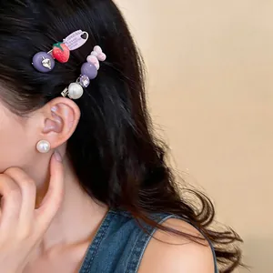 Close-up of strawberry and pearl hair clips on model in Korean style