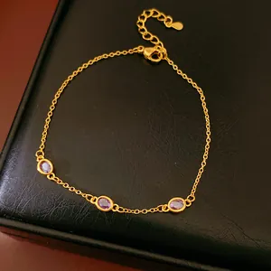 Nahaufnahme eines eleganten Goldarmbands mit drei ovalen lila Edelsteinen für Damen.