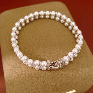 Elegant double-layer pearl bracelet with sparkling zirconia pave clasp on display box
