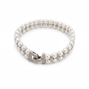Elegant double-layered white faux pearl bracelet featuring a zircon-studded silver clasp