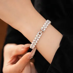 Close-up of elegant double-layer pearl bracelet with zircon clasp on wrist
