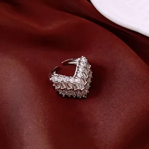 Luxury vintage V-shaped ring with cluster rhinestones on deep red fabric background