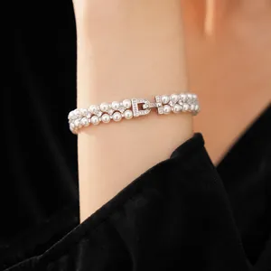 Close-up view of double-layer pearl bracelet with zircon accents on model wrist